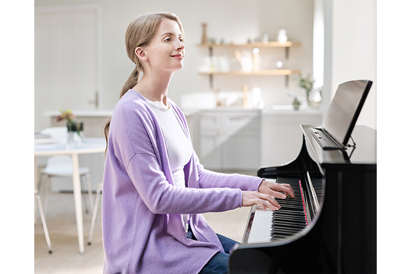 A person playing Yamaha Clavinova CLP-875PE with a pleasant feeling