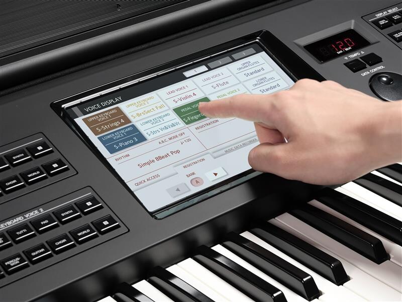 User operating a large touch-panel LCD screen.
