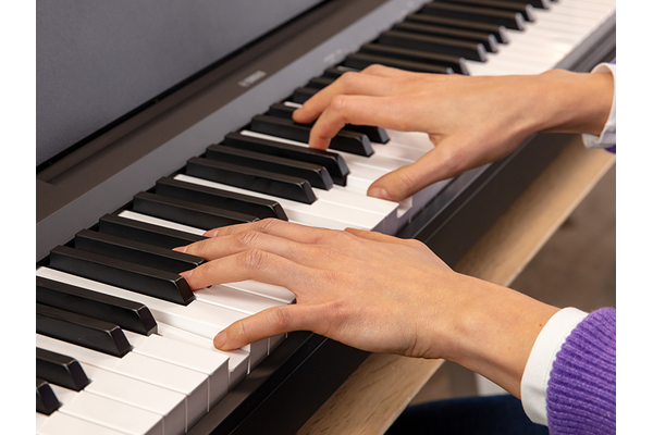 The hands of a person playing the P-145BT